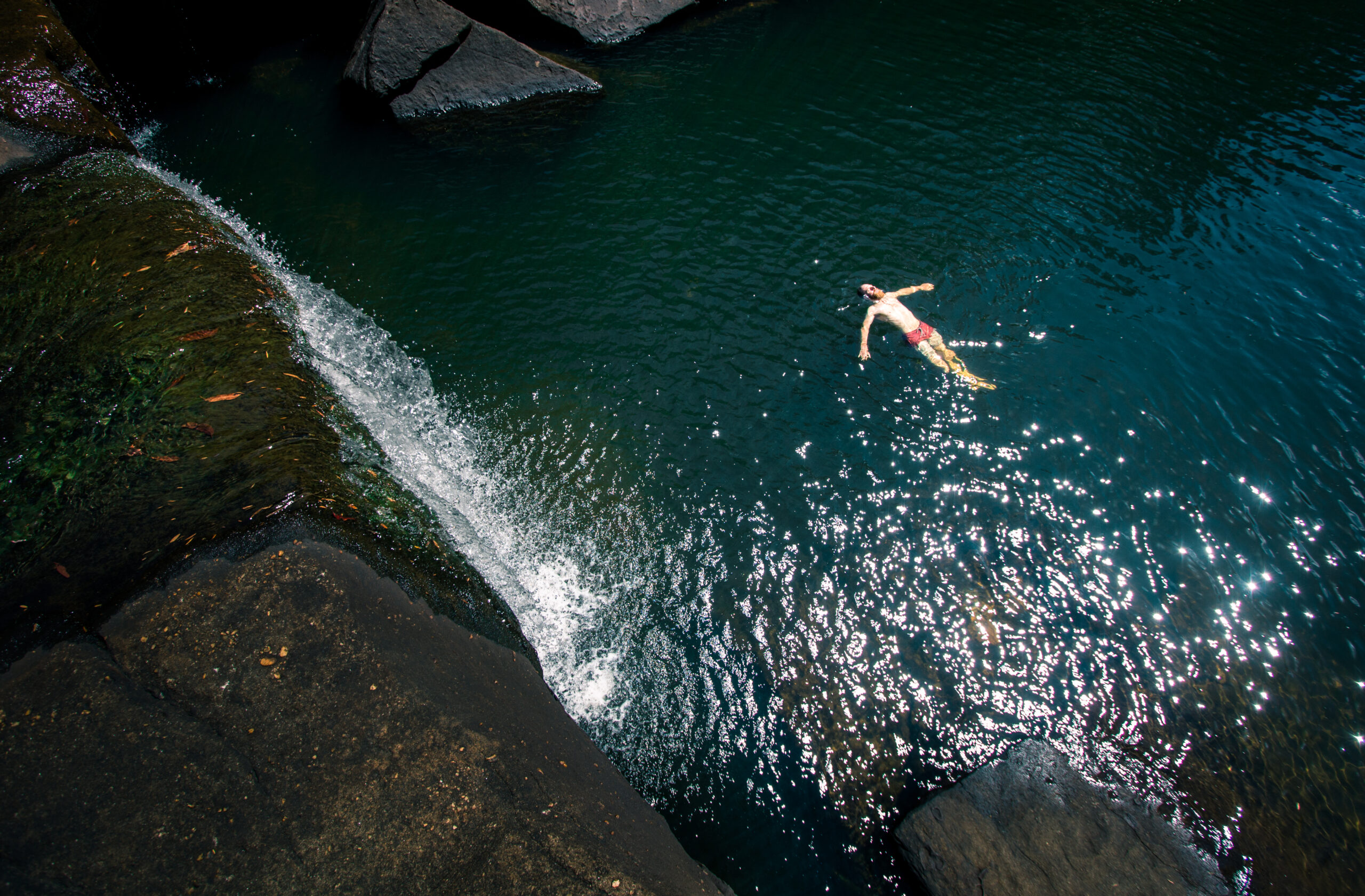 person floating in waterhole