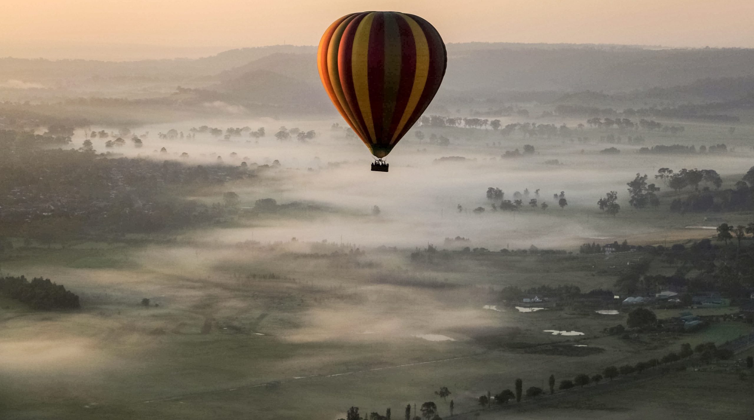 Hot Air Balloon over foggy valley in the Macarthur region.