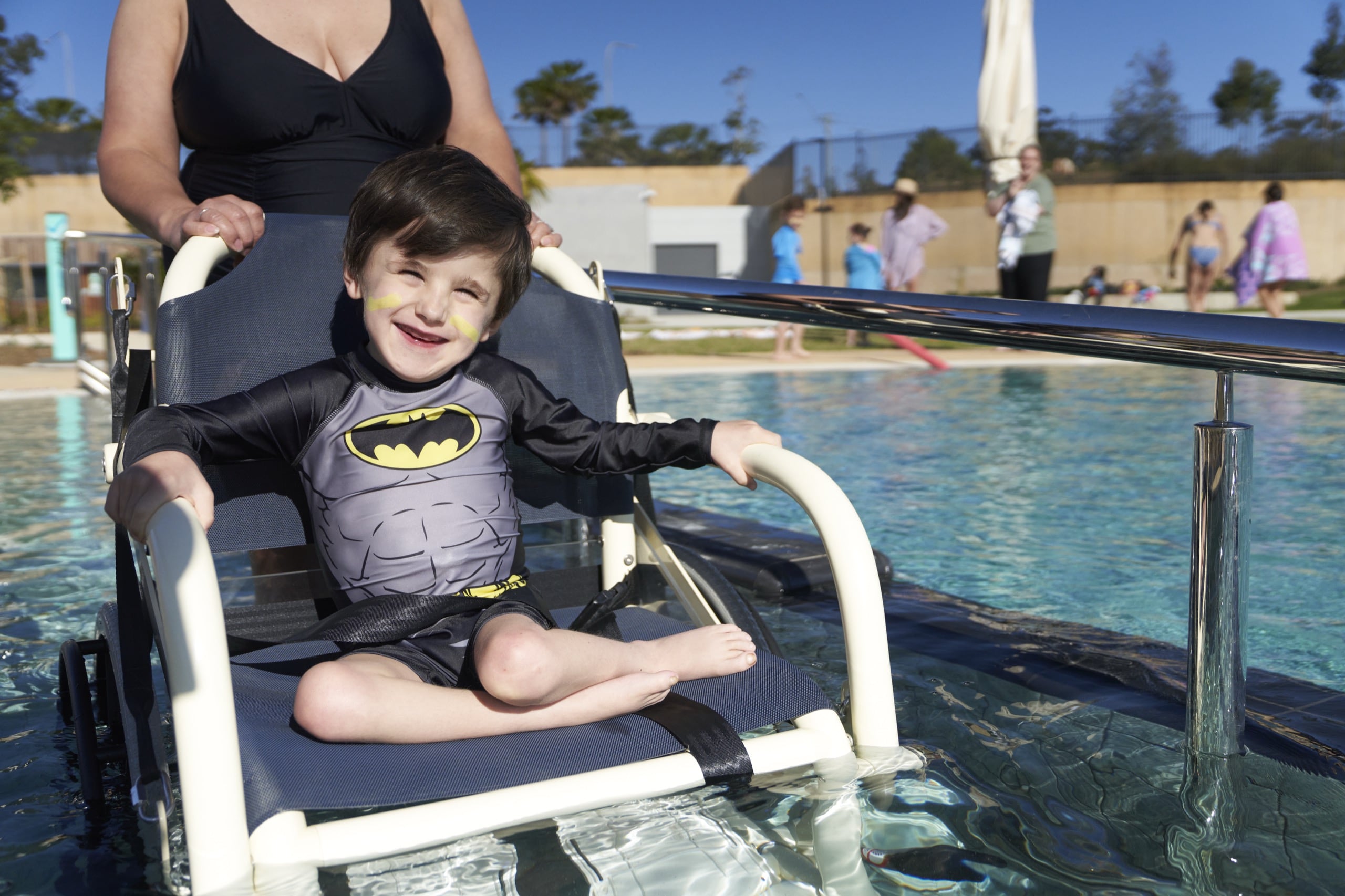 child in wheelchair in swimming pool